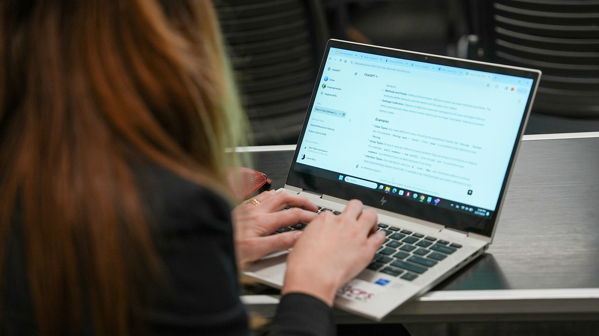 Woman working with AI on laptop