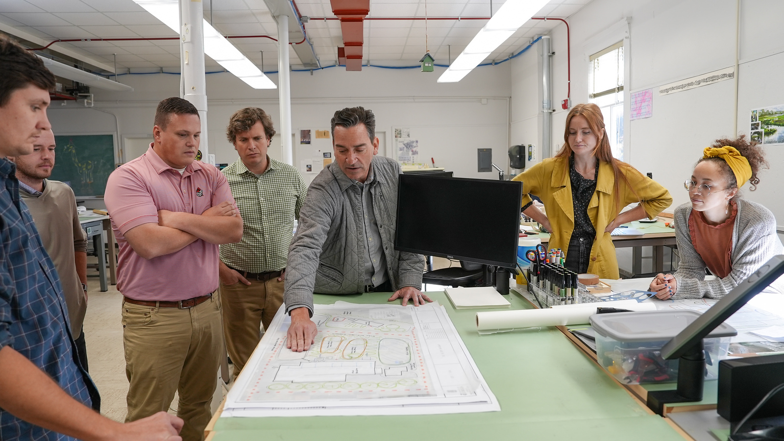 Group of people around a draft landscape