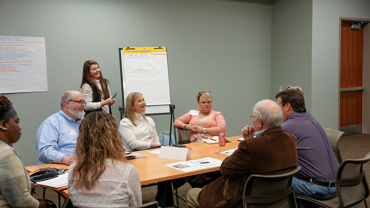 woman presenting to others in a room