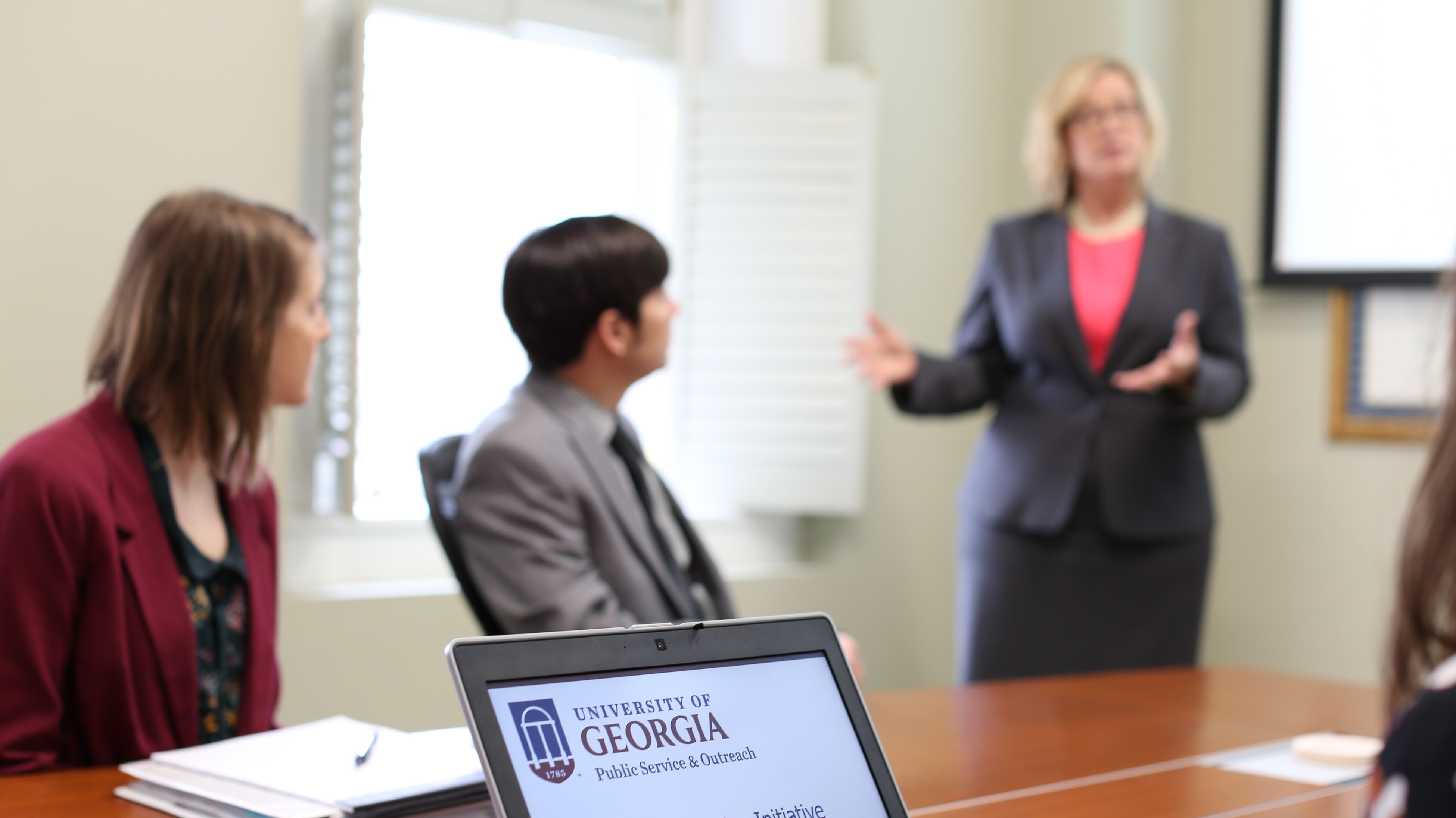 woman presenting to a group of people